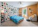 A colorful bedroom with an accent wall, soft carpet, ceiling fan, and window with natural light at 11808 Venture Oak Way, Raleigh, NC 27613