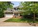 Charming two-story home featuring a brick-accented porch and attached two-car garage at 11808 Venture Oak Way, Raleigh, NC 27613