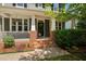 Close-up of the home's inviting front porch with brick accents and charming details at 11808 Venture Oak Way, Raleigh, NC 27613