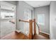 Bright upstairs hallway features hardwood floors and view to carpeted bedroom through an open doorway at 11808 Venture Oak Way, Raleigh, NC 27613