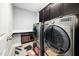 Functional laundry room featuring modern appliances and ample counter space at 11808 Venture Oak Way, Raleigh, NC 27613