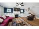 Elegant living room with built-in cabinets, fireplace, and modern ceiling fan at 11808 Venture Oak Way, Raleigh, NC 27613