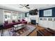 Comfortable living room with a fireplace, built-in shelves, and large windows at 11808 Venture Oak Way, Raleigh, NC 27613