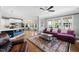 Open-concept living space featuring hardwood floors, a cozy sofa, and bright natural light at 11808 Venture Oak Way, Raleigh, NC 27613