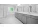 A luxurious main bathroom featuring dual vanity sinks, a glass shower and soaking tub at 11808 Venture Oak Way, Raleigh, NC 27613