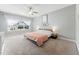 Spacious main bedroom with a ceiling fan, carpeted floors, large windows, and gray paint at 11808 Venture Oak Way, Raleigh, NC 27613