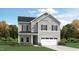 Charming two-story home with a welcoming facade, lush landscaping, and attached garage at 1201 Jade Valley Trl, Raleigh, NC 27610