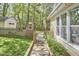 Well-maintained backyard with a shed, stone pathway, and lush greenery, perfect for outdoor enjoyment at 1203 Queensbury Cir, Durham, NC 27713