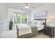 Comfortable bedroom with a queen bed, ceiling fan, large window, and neutral decor at 1203 Queensbury Cir, Durham, NC 27713