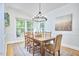 Charming dining room featuring a classic chandelier, large windows, and comfortable seating at 1203 Queensbury Cir, Durham, NC 27713