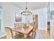 Bright dining room featuring a classic chandelier, dining table, and comfortable seating at 1203 Queensbury Cir, Durham, NC 27713