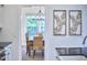 Dining room with hardwood floors, decorative lighting, and large windows providing natural light at 1203 Queensbury Cir, Durham, NC 27713