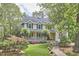 Charming two-story home with a welcoming front porch, landscaped yard, and classic architectural details at 1203 Queensbury Cir, Durham, NC 27713