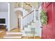Inviting foyer with a charming red front door, staircase, and warm hardwood floors at 1203 Queensbury Cir, Durham, NC 27713