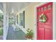 Charming front porch with rocking chairs and a bright red door, perfect for enjoying the outdoors at 1203 Queensbury Cir, Durham, NC 27713