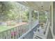 Spacious front porch with rocking chairs offering a relaxing outdoor space with views of the landscaped yard at 1203 Queensbury Cir, Durham, NC 27713