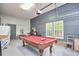 Finished game room with pool table, overhead projector, and modern accent wall at 1203 Queensbury Cir, Durham, NC 27713