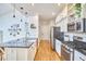 Modern kitchen featuring black countertops, white cabinets, and stainless steel appliances at 1203 Queensbury Cir, Durham, NC 27713