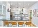 Bright kitchen with stainless appliances, black countertops, and open shelving, perfect for entertaining at 1203 Queensbury Cir, Durham, NC 27713