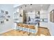 Modern kitchen features stainless appliances, a breakfast bar with seating, and bright white cabinetry at 1203 Queensbury Cir, Durham, NC 27713