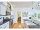 Bright kitchen featuring a farmhouse sink, stainless steel appliances, and hardwood floors at 1203 Queensbury Cir, Durham, NC 27713