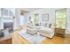 Inviting living room with hardwood floors, a cozy sectional sofa, and a decorative fireplace at 1203 Queensbury Cir, Durham, NC 27713