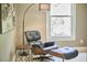 Cozy room with an accent chair and ottoman and modern lighting at 1203 Queensbury Cir, Durham, NC 27713