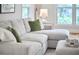 Comfortable living room featuring a sectional sofa, natural light, and stylish decor at 1203 Queensbury Cir, Durham, NC 27713