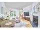 Bright living room featuring a fireplace, large windows, and a comfortable sectional sofa at 1203 Queensbury Cir, Durham, NC 27713