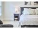 Bedside table with lamp and decor in neutral toned main bedroom at 1203 Queensbury Cir, Durham, NC 27713