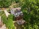 Aerial view of a home showcasing a backyard deck, patio, and lush greenery at 1209 Kingston Ridge Rd, Cary, NC 27511