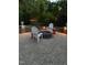 Inviting brick backyard patio featuring a charming fire pit and comfortable seating at 1209 Kingston Ridge Rd, Cary, NC 27511