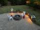 Well-lit backyard patio with inviting seating area, fire pit, and lush green surroundings at 1209 Kingston Ridge Rd, Cary, NC 27511