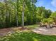 Spacious backyard featuring a charming patio area with outdoor seating and fire pit at 1209 Kingston Ridge Rd, Cary, NC 27511