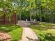 A lovely backyard patio with outdoor seating and fire pit overlooks green backyard at 1209 Kingston Ridge Rd, Cary, NC 27511