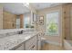 Well-lit bathroom featuring a granite countertop, neutral tones, and decorative accents, offering a serene and stylish space at 1209 Kingston Ridge Rd, Cary, NC 27511