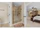 Bathroom with large walk-in shower, tile surround and doorway to bedroom at 1209 Kingston Ridge Rd, Cary, NC 27511