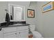 Well-maintained powder room featuring a granite countertop, vanity, and toilet at 1209 Kingston Ridge Rd, Cary, NC 27511