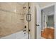 Elegant tiled shower and tub with glass door and modern fixtures, adjacent to a hallway entrance at 1209 Kingston Ridge Rd, Cary, NC 27511