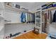 Organized walk-in closet featuring hardwood floors, ample shelving, and hanging space for efficient storage at 1209 Kingston Ridge Rd, Cary, NC 27511