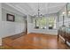 Bright dining room featuring hardwood floors, paneled walls, and large windows at 1209 Kingston Ridge Rd, Cary, NC 27511