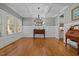 Elegant dining room with coffered ceilings, hardwood floors, and a stylish chandelier at 1209 Kingston Ridge Rd, Cary, NC 27511