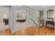 Hallway view with hardwood flooring and a partial view into a primary bedroom, showcasing the home's layout at 1209 Kingston Ridge Rd, Cary, NC 27511