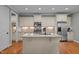 Modern kitchen with center island, stainless appliances, granite counters, and ample cabinetry at 1209 Kingston Ridge Rd, Cary, NC 27511