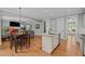 Open kitchen featuring an island with a sink, granite countertops, and stainless steel dishwasher at 1209 Kingston Ridge Rd, Cary, NC 27511