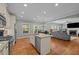 Spacious kitchen featuring stainless appliances, granite countertops, hardwood floors, and a central island at 1209 Kingston Ridge Rd, Cary, NC 27511