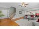 Open-concept living area showcasing hardwood floors, a staircase, and seamless flow into the kitchen at 1209 Kingston Ridge Rd, Cary, NC 27511