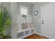Functional mudroom with built-in bench seating, storage, and natural light from the window at 1209 Kingston Ridge Rd, Cary, NC 27511