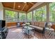 Comfortable screened porch featuring wood ceiling, ceiling fan, and wicker furniture at 1209 Kingston Ridge Rd, Cary, NC 27511
