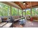 Screened porch with a ceiling fan, wicker furniture, and view to the back yard at 1209 Kingston Ridge Rd, Cary, NC 27511